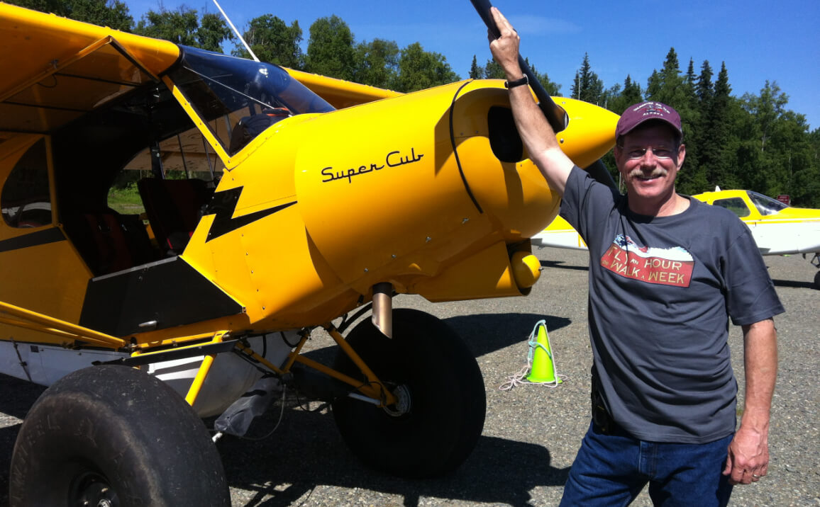 Dr. McNamara next to Alaskan bush plane