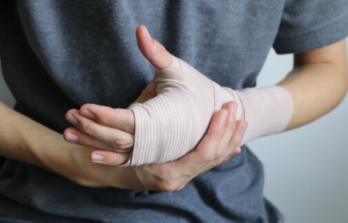 Orthopedic patient holds injured hand