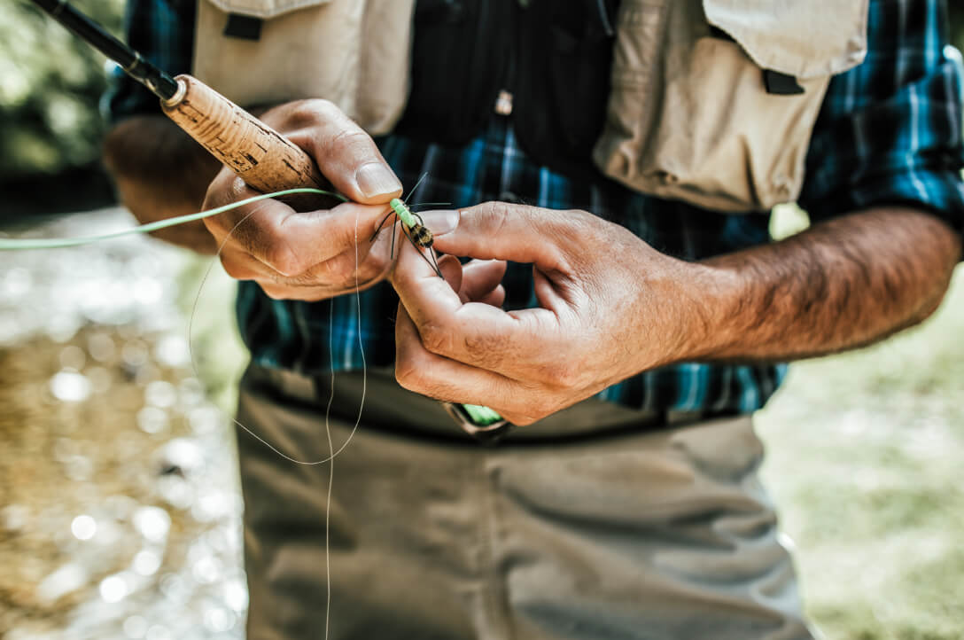 Orthopedic patient ties flies while fly fishing in Alaska