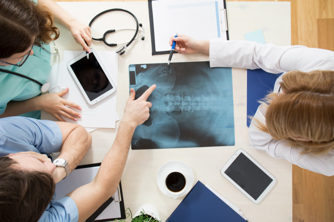 Orthopedic doctors review scans of hip injury