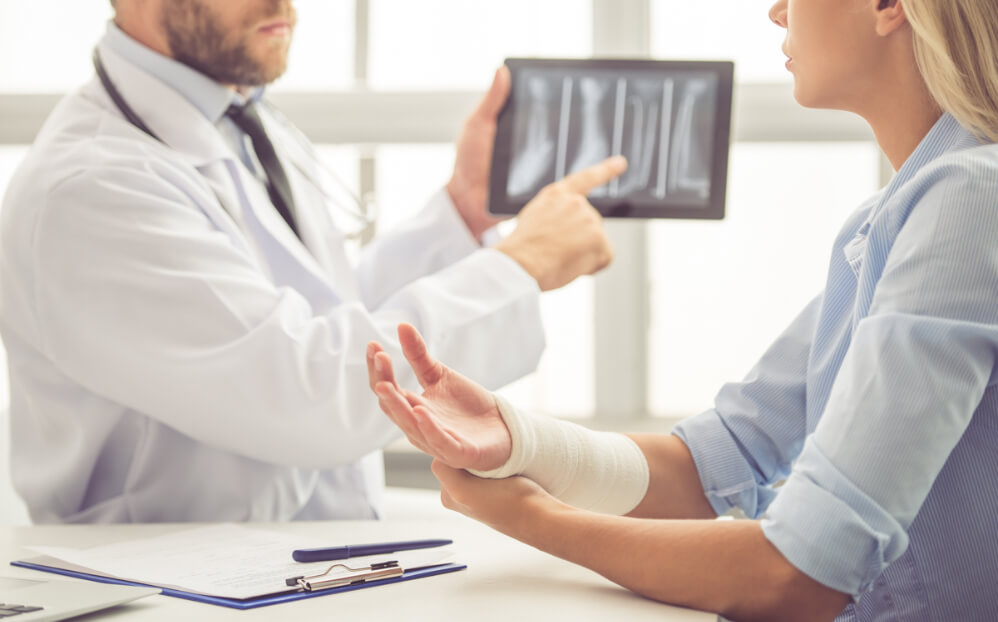 Orthopedic doctor shows patient scans of fracture in Anchorage, Alaska
