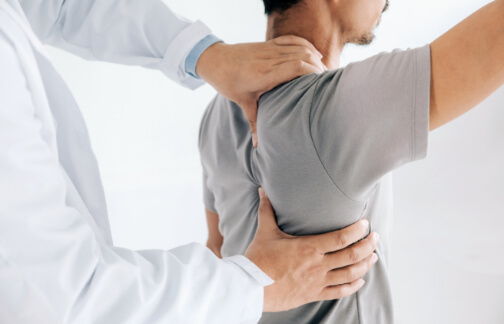 Orthopedic doctor examines patient shoulder