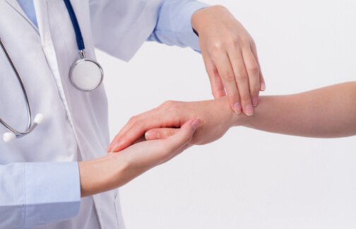 Orthopedic doctor examines patient wrist